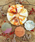 Wax Melts - Wax Pop products on a wooden surface with decorative elements