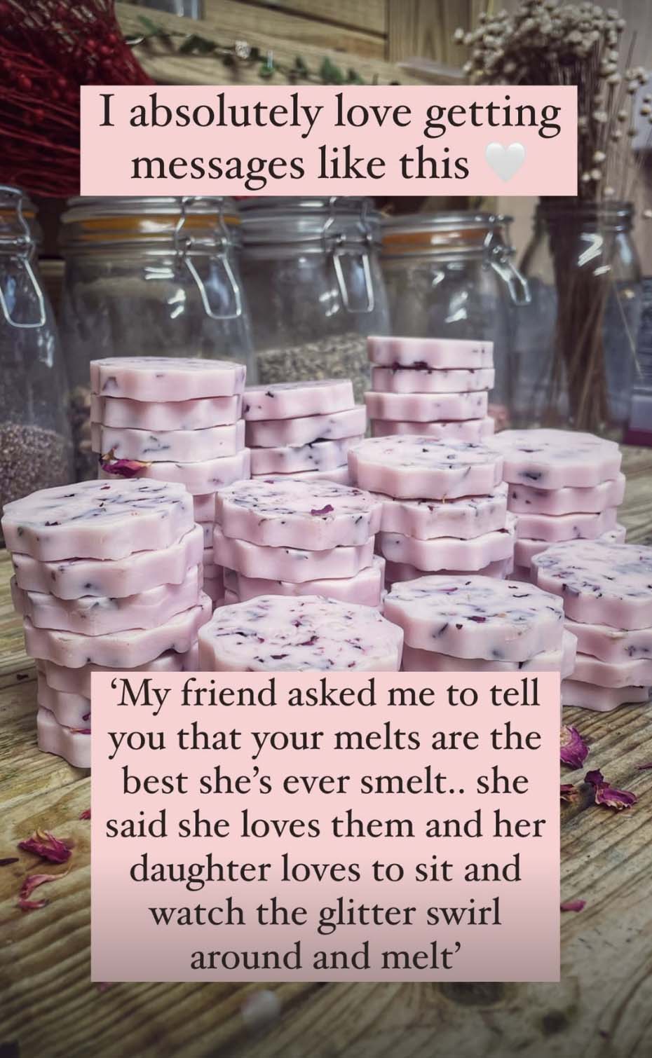 Stack of pink wax melts with testimonial overlay on a wooden surface